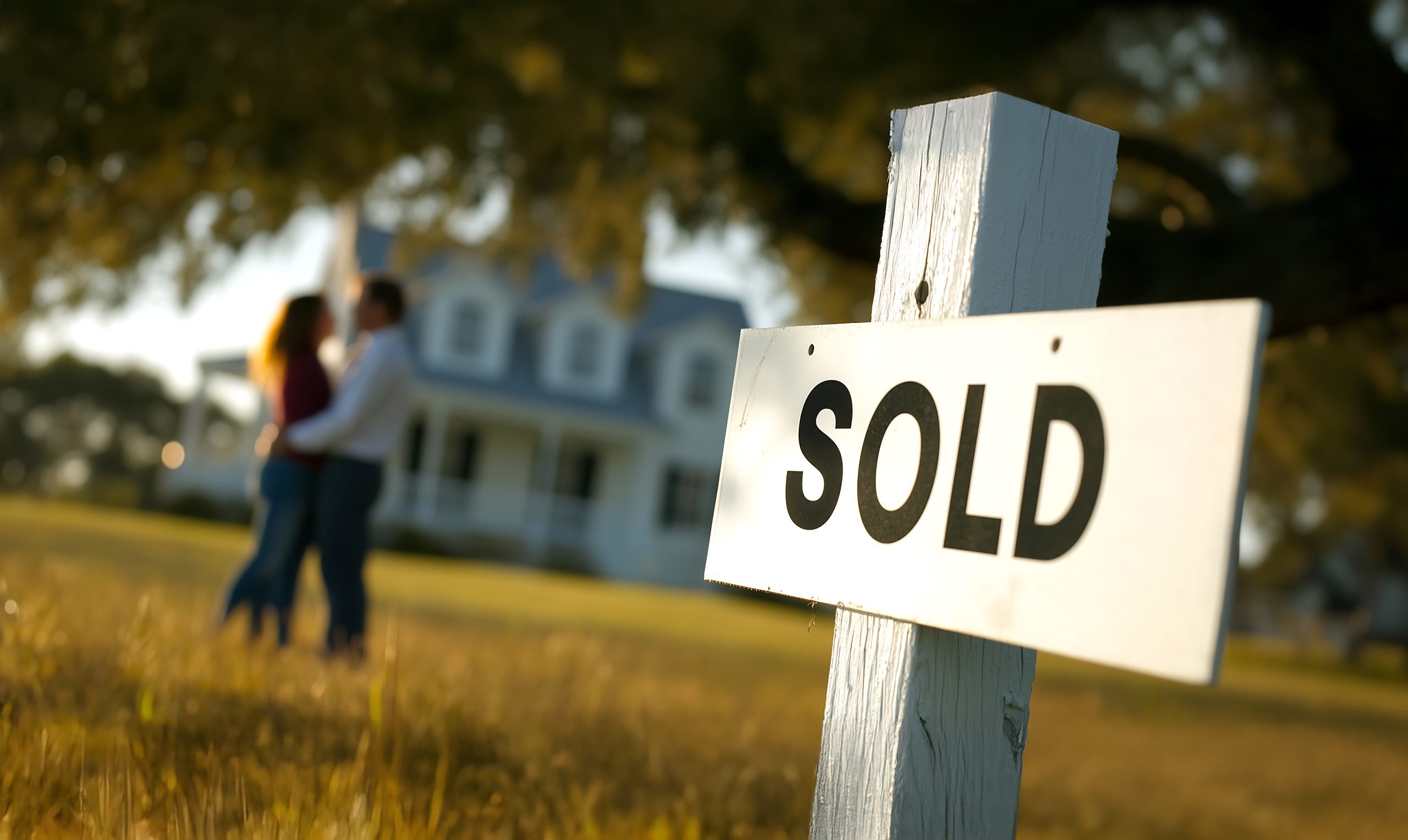 Happy couple with sold home